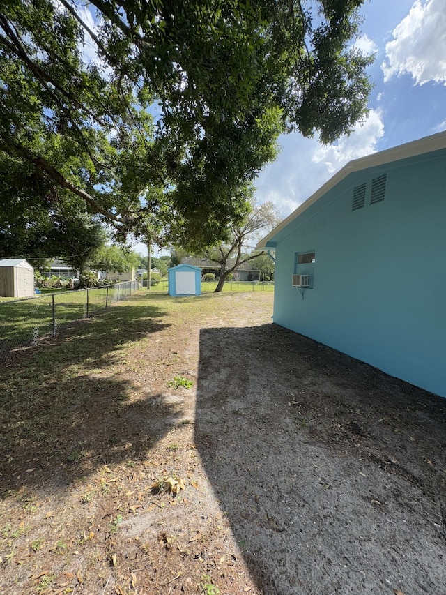7507 Arthurs Rd, Fort Pierce, FL 34951 - view of yard with an outbuilding, a storage unit, and fence