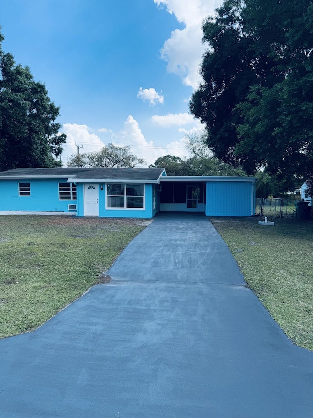 7507 Arthurs Rd, Fort Pierce, FL 34951 - single story home with a front yard, fence, a carport, and driveway
