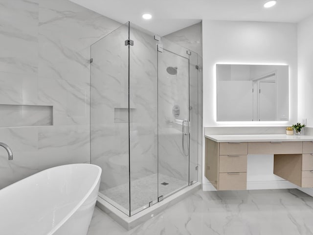 full bathroom with a marble finish shower, vanity, a freestanding tub, marble finish floors, and recessed lighting