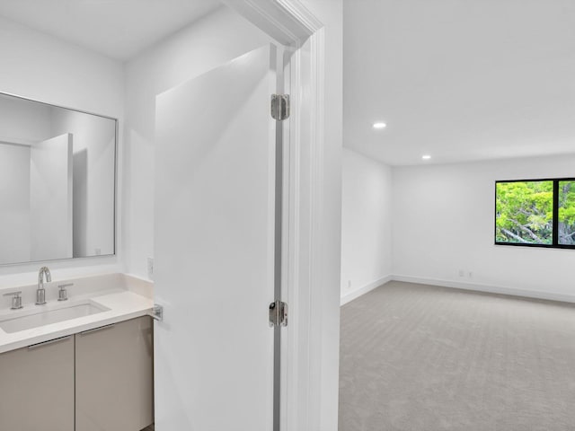 bathroom featuring recessed lighting, vanity, and baseboards
