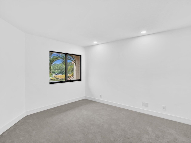 carpeted empty room with recessed lighting and baseboards