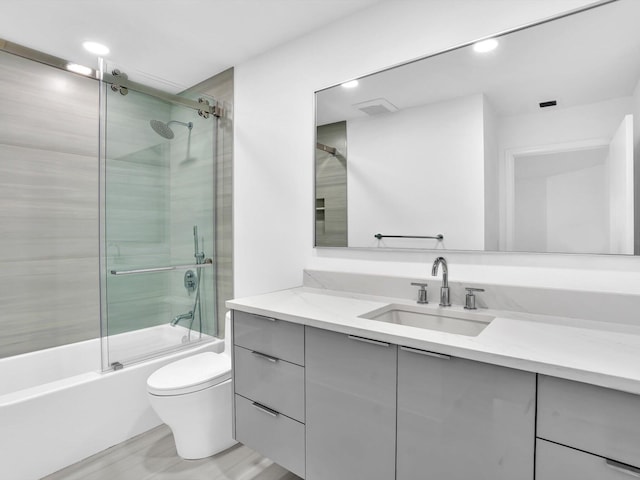full bathroom with toilet, vanity, shower / bath combination with glass door, and recessed lighting