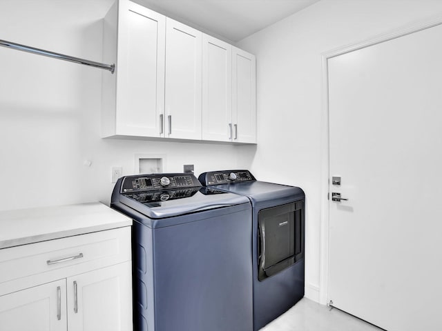 clothes washing area with cabinet space and washer and clothes dryer