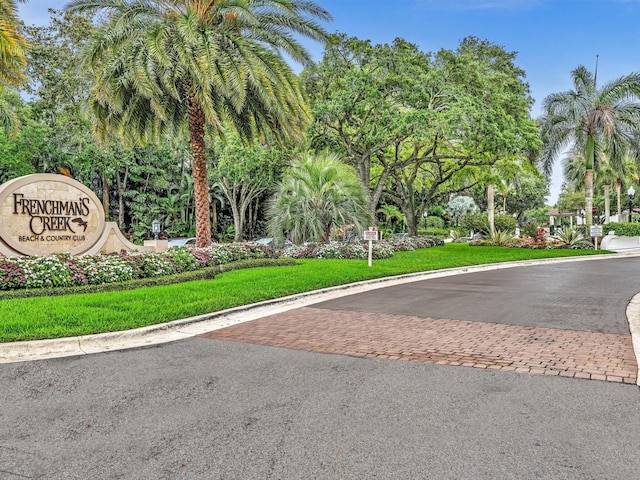 view of asphalt road featuring curbs