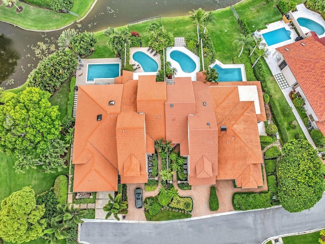 aerial view of a pool area and a large body of water