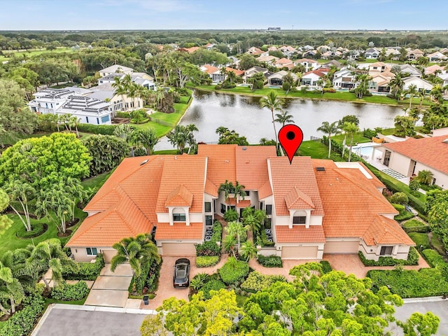 aerial view of residential area featuring a large body of water