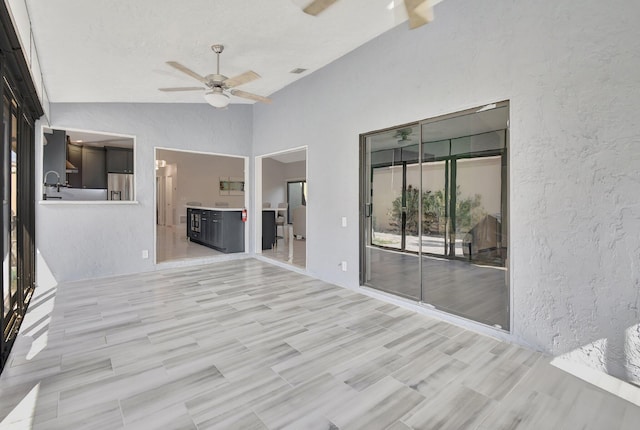 2430 NW 14th St, Delray Beach, FL 33445 - spare room featuring lofted ceiling, ceiling fan, a textured wall, and light wood-type flooring