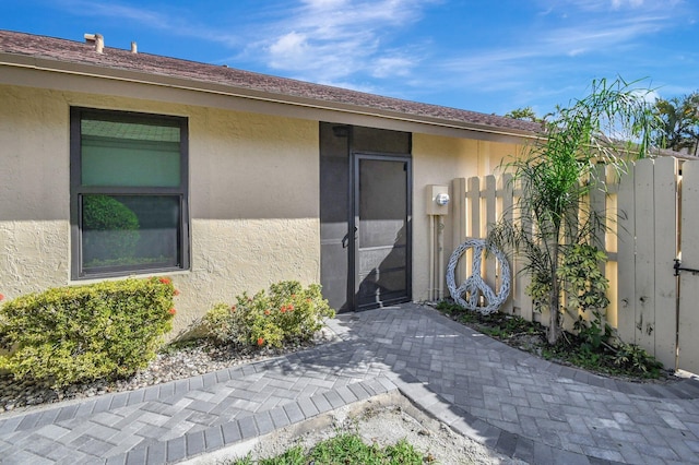 2430 NW 14th St, Delray Beach, FL 33445 - doorway to property featuring stucco siding