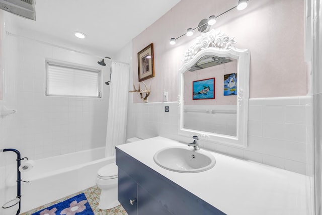 910 Dolphin Dr, Jupiter, FL 33458 - bathroom with a wainscoted wall, toilet, vanity, shower / bathtub combination with curtain, and tile walls
