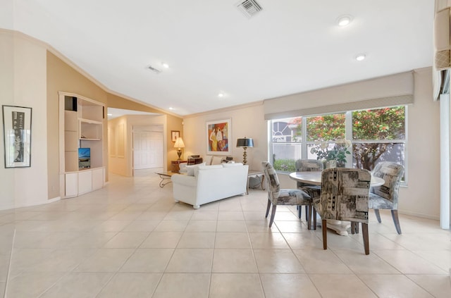 dining area with crown molding, lofted ceiling, light tile patterned floors, visible vents, and built in features