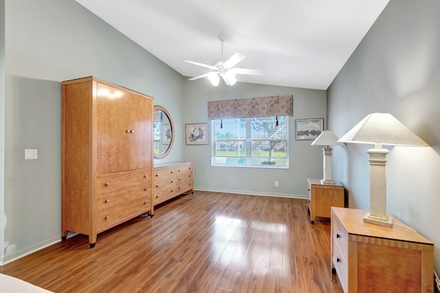 bedroom featuring baseboards, lofted ceiling, light wood finished floors, and ceiling fan