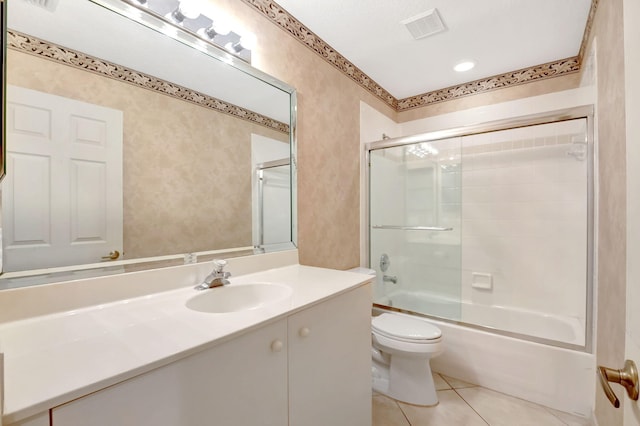 full bathroom featuring visible vents, combined bath / shower with glass door, toilet, vanity, and tile patterned flooring