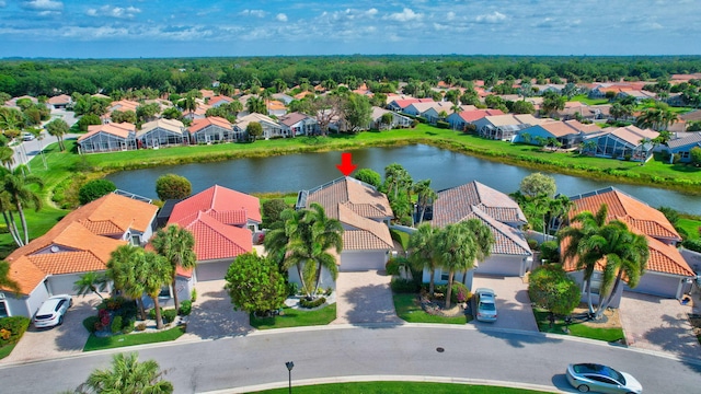 drone / aerial view with a residential view and a water view