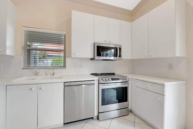 kitchen with ornamental molding, a sink, stainless steel appliances, and light countertops