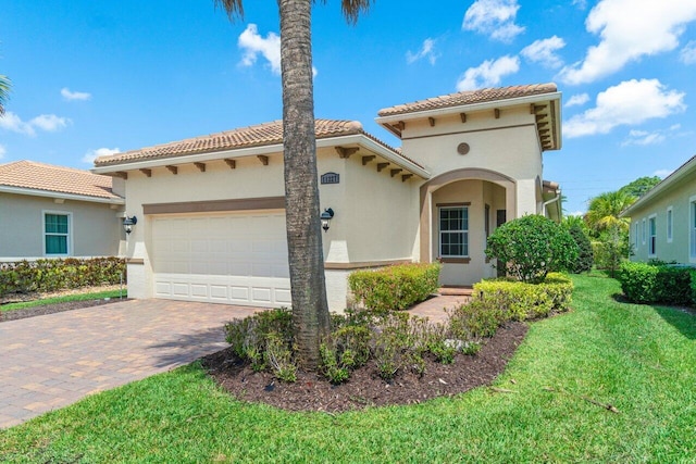 11227 SW Visconti Way, Port Saint Lucie, FL 34986 - mediterranean / spanish home with a tile roof, decorative driveway, a front lawn, a garage, and stucco siding