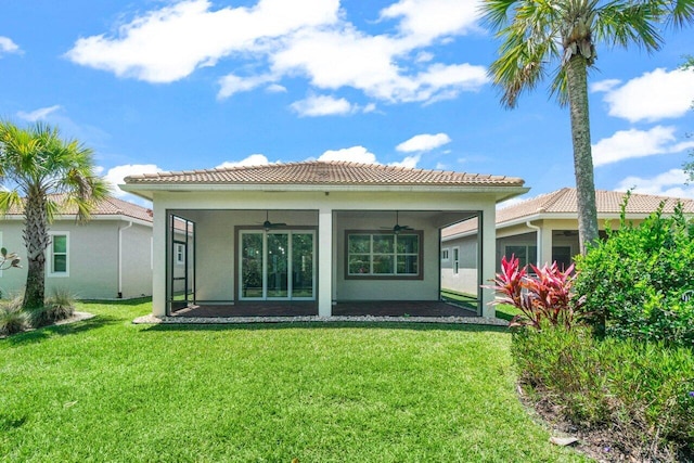 11227 SW Visconti Way, Port Saint Lucie, FL 34986 - back of property featuring a lawn, a ceiling fan, a tiled roof, stucco siding, and a sunroom