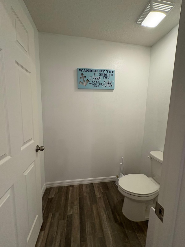 1938 SW Monterrey Ln, Port Saint Lucie, FL 34953 - bathroom featuring toilet, baseboards, and wood finished floors