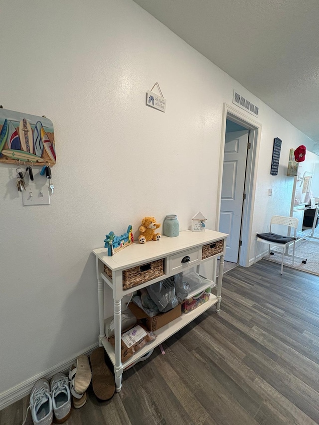 1938 SW Monterrey Ln, Port Saint Lucie, FL 34953 - corridor featuring visible vents, baseboards, and dark wood-style floors