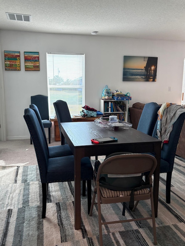 1938 SW Monterrey Ln, Port Saint Lucie, FL 34953 - dining area with a textured ceiling, carpet, and visible vents