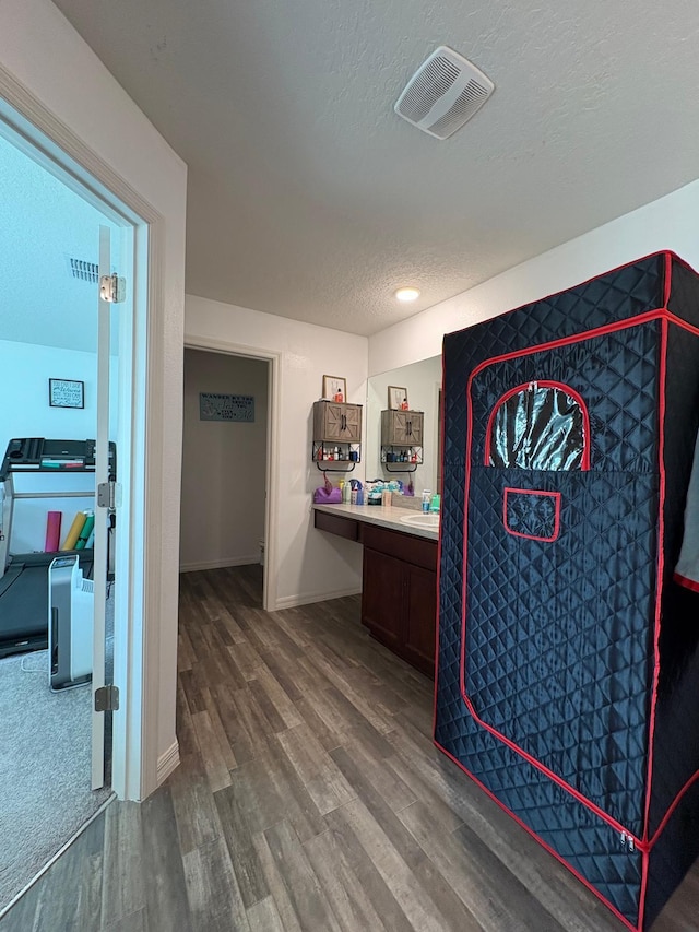 1938 SW Monterrey Ln, Port Saint Lucie, FL 34953 - interior space featuring baseboards, visible vents, a textured ceiling, and wood finished floors