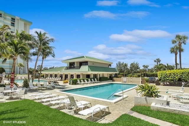 pool featuring fence and a patio