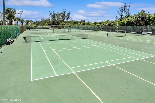 view of tennis court featuring fence and community basketball court