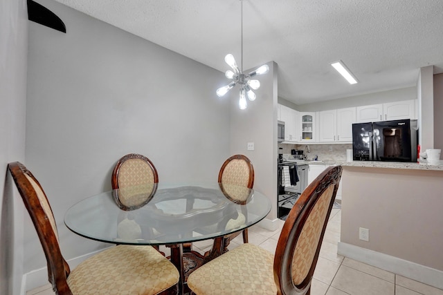 9441 W Mcnab Rd Unit 111, Tamarac, FL 33321 - dining area featuring light tile patterned flooring, baseboards, and a textured ceiling