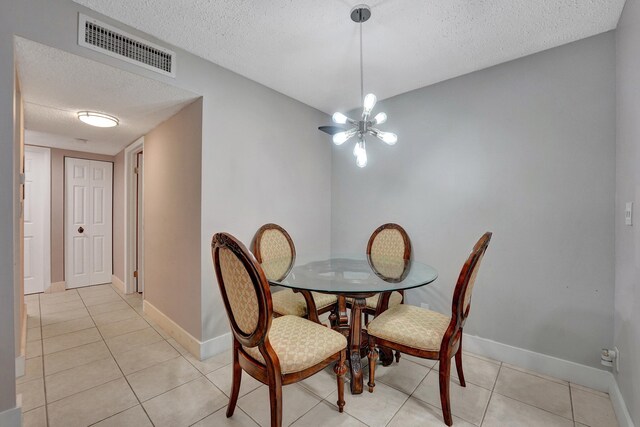 9441 W Mcnab Rd Unit 111, Tamarac, FL 33321 - dining area with a textured ceiling, light tile patterned floors, and baseboards