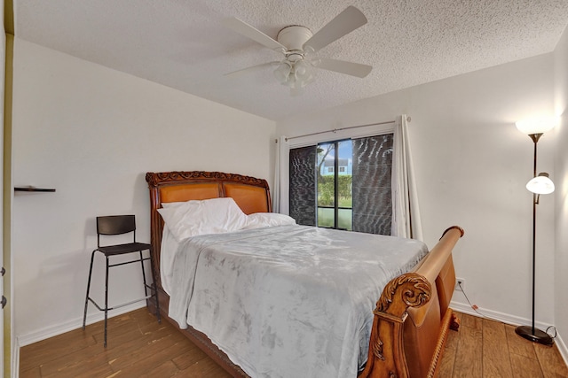 9441 W Mcnab Rd Unit 111, Tamarac, FL 33321 - bedroom featuring hardwood / wood-style floors, baseboards, a textured ceiling, and ceiling fan
