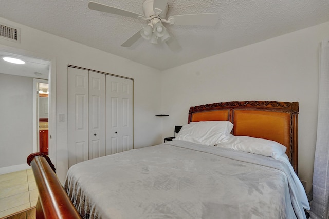 9441 W Mcnab Rd Unit 111, Tamarac, FL 33321 - bedroom featuring a closet, ceiling fan, tile patterned flooring, and a textured ceiling