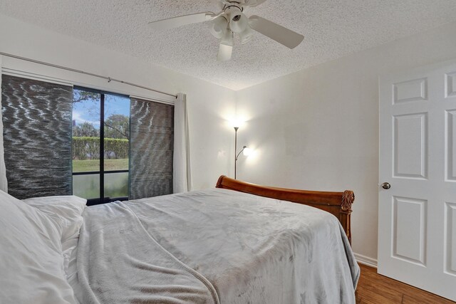 9441 W Mcnab Rd Unit 111, Tamarac, FL 33321 - bedroom with a textured ceiling, wood finished floors, and ceiling fan