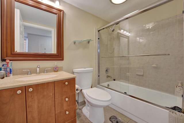 9441 W Mcnab Rd Unit 111, Tamarac, FL 33321 - bathroom featuring vanity, tile patterned flooring, enclosed tub / shower combo, and toilet