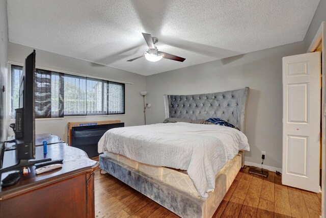 9441 W Mcnab Rd Unit 111, Tamarac, FL 33321 - bedroom featuring a textured ceiling, light wood-style flooring, and a ceiling fan