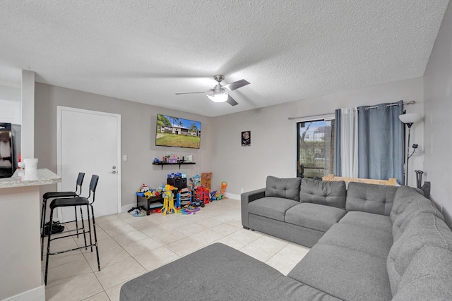 9441 W Mcnab Rd Unit 111, Tamarac, FL 33321 - living room featuring a ceiling fan, light tile patterned flooring, a textured ceiling, and baseboards