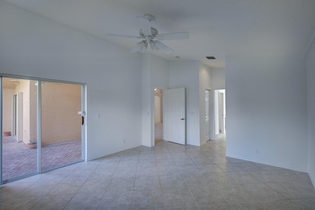 spare room with light tile patterned flooring, visible vents, high vaulted ceiling, and a ceiling fan