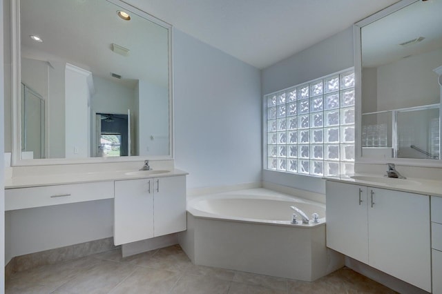 full bath with a bath, a sink, a shower stall, and visible vents