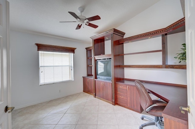 unfurnished office featuring light tile patterned flooring, a textured ceiling, baseboards, and a ceiling fan