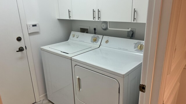 laundry area with washer and clothes dryer and cabinet space