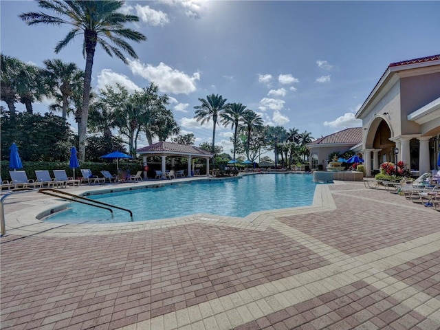 pool with a gazebo and a patio area