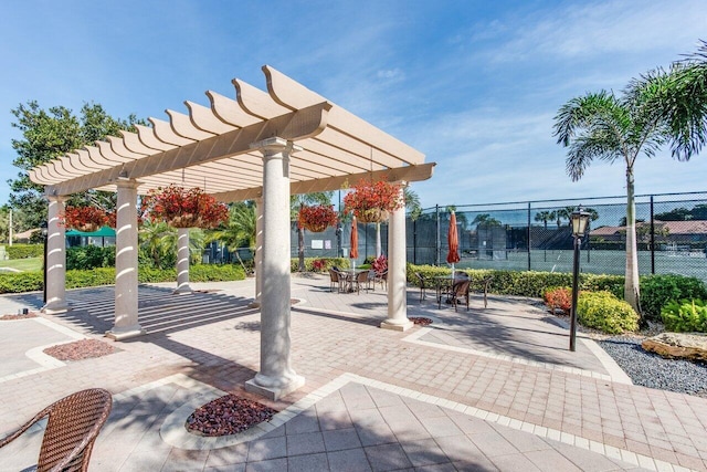 view of patio / terrace featuring a pergola and fence