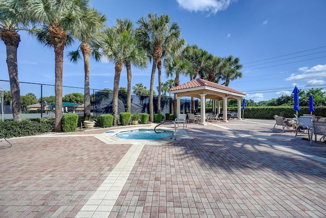 view of pool with a patio, fence, and a gazebo