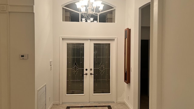 view of exterior entry with french doors and visible vents