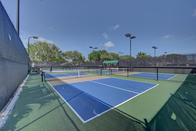 view of tennis court featuring fence