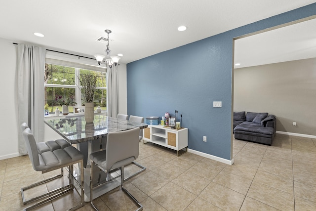 dining area with a chandelier, light tile patterned floors, recessed lighting, a textured wall, and baseboards