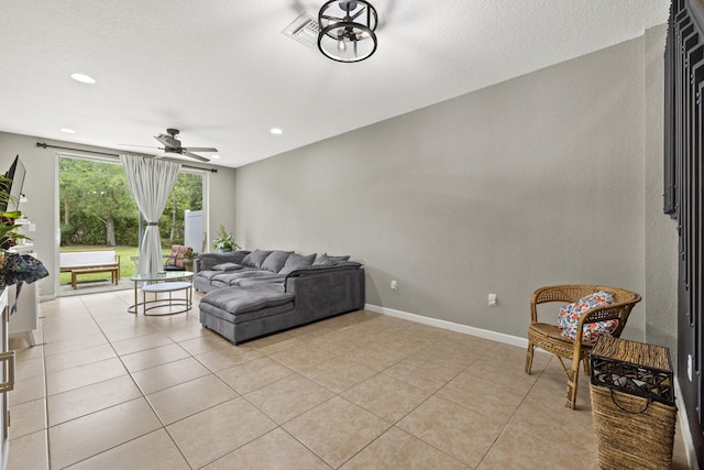 living room featuring a ceiling fan, light tile patterned flooring, recessed lighting, and baseboards