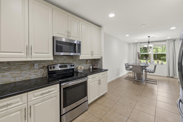 kitchen featuring appliances with stainless steel finishes, baseboards, backsplash, light tile patterned floors, and recessed lighting