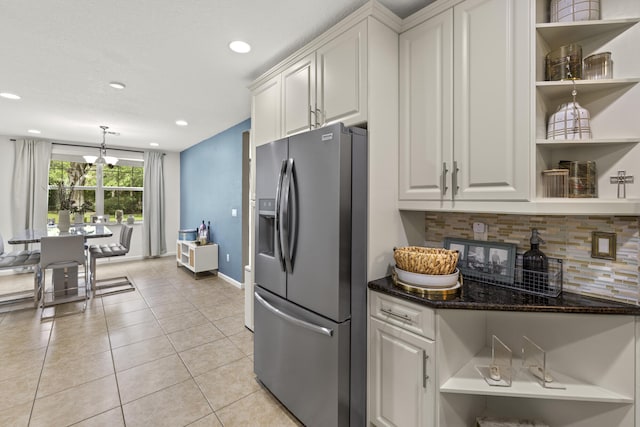 kitchen featuring stainless steel refrigerator with ice dispenser, open shelves, decorative backsplash, white cabinetry, and recessed lighting