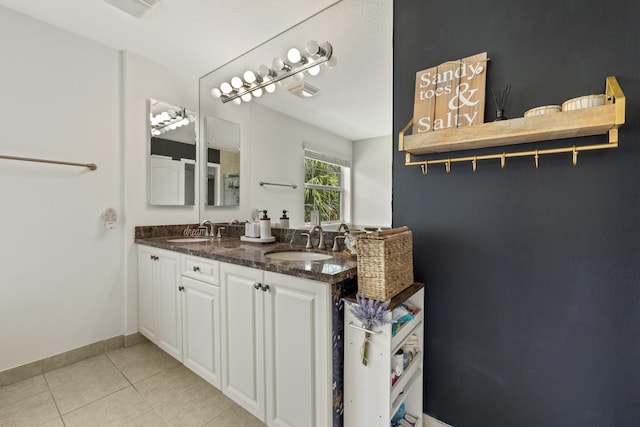 full bathroom with tile patterned floors, double vanity, and baseboards