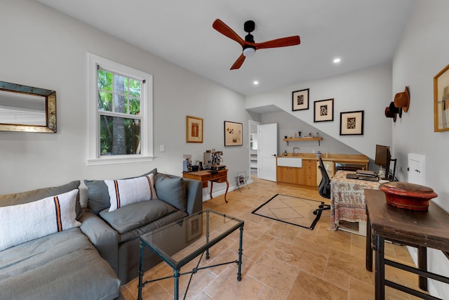 living room featuring stone tile floors, a ceiling fan, and recessed lighting