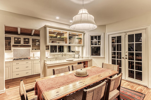 dining space featuring french doors, recessed lighting, and light wood-style flooring